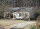 Dilapidated single-story home with weathered wood and overgrown greenery, displaying the property's potential at 526 Mount Carmel Church Rd, Temple, GA 30179