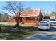 Charming home with covered front porch, surrounded by mature trees and parking in the front yard at 526 Mount Carmel Church Rd, Temple, GA 30179
