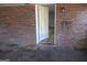 A dirty exterior brick wall with an open doorway is shown at 526 Mount Carmel Church Rd, Temple, GA 30179