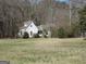 Quaint two-story home with a large front yard surrounded by mature trees providing a serene and private setting at 526 Mount Carmel Church Rd, Temple, GA 30179