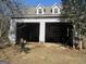 A two-car garage features open bays for storage, with the roofline featuring two dormer windows at 526 Mount Carmel Church Rd, Temple, GA 30179