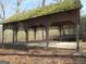 Image shows the exterior of an old gazebo with lattice detail work surrounding it at 526 Mount Carmel Church Rd, Temple, GA 30179