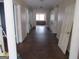 Long hallway with wood floors and white trim leading to a window-lit room at 526 Mount Carmel Church Rd, Temple, GA 30179