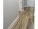 Hallway featuring wood-look floors, white trim, and access to multiple rooms at 526 Mount Carmel Church Rd, Temple, GA 30179