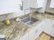 Kitchen featuring white cabinets, granite countertops, and stainless steel sink at 526 Mount Carmel Church Rd, Temple, GA 30179