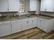 White cabinets and granite countertops, complemented by stainless steel sink at 526 Mount Carmel Church Rd, Temple, GA 30179