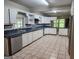 Spacious kitchen featuring white cabinets, stainless steel appliances, and tiled flooring offering functionality at 526 Mount Carmel Church Rd, Temple, GA 30179