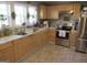 A bright kitchen featuring light cabinets, stainless steel appliances, and a window over the sink at 526 Mount Carmel Church Rd, Temple, GA 30179