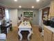 A cozy kitchen with two tables and chairs, a hutch, light gray walls, and modern appliances at 526 Mount Carmel Church Rd, Temple, GA 30179
