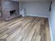 Bright living room featuring wood flooring and a red brick fireplace at 526 Mount Carmel Church Rd, Temple, GA 30179