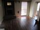 Cozy living room with a brick fireplace and large window, creating a warm and inviting atmosphere at 526 Mount Carmel Church Rd, Temple, GA 30179