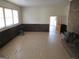 Expansive living room with classic wood paneling, brick fireplace, and natural light offering a cozy atmosphere at 526 Mount Carmel Church Rd, Temple, GA 30179