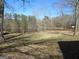 Backyard view of the property's pond and surrounding landscape at 526 Mount Carmel Church Rd, Temple, GA 30179