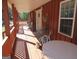 Inviting porch with lots of chairs, table, and rustic wood plank flooring at 526 Mount Carmel Church Rd, Temple, GA 30179