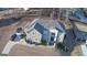 Stunning aerial view of a gray stone two-story home with a well-manicured lawn and ample parking at 116 Kalsum Trl, Ellenwood, GA 30294