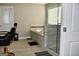 This primary bathroom features a walk-in shower, soaking tub, tile surround, and unique vanity at 116 Kalsum Trl, Ellenwood, GA 30294