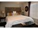 This bedroom features a king sized bed, neutral wall colors, and decorative mirror at 116 Kalsum Trl, Ellenwood, GA 30294