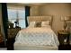 This cozy bedroom boasts a patterned duvet, soft headboard, and stylish accent table at 116 Kalsum Trl, Ellenwood, GA 30294