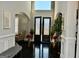 Welcoming foyer with arched entryways, decorative front doors, and hardwood floors at 116 Kalsum Trl, Ellenwood, GA 30294