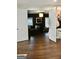 A modern living room is shown through open, white double doors, with a dark sofa and wood flooring at 116 Kalsum Trl, Ellenwood, GA 30294