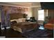 This spacious main bedroom boasts an eye-catching accent wall and cozy seating area at 116 Kalsum Trl, Ellenwood, GA 30294