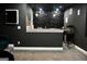 This theater room is equipped with a popcorn machine, wet bar, and geometric paneling for movie nights at 116 Kalsum Trl, Ellenwood, GA 30294