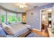 Large primary bedroom features a ceiling fan, a window seat, and natural light from the big windows at 120 Majesty Ln, Fayetteville, GA 30215