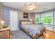 This bedroom features a ceiling fan, wooden floors, a large window, and a cozy window seat at 120 Majesty Ln, Fayetteville, GA 30215