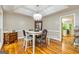 Cozy dining room featuring a tray ceiling, hardwood floors, and large windows at 120 Majesty Ln, Fayetteville, GA 30215