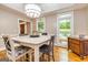 Comfortable dining room featuring a bright light fixture, hardwood floors, and large windows at 120 Majesty Ln, Fayetteville, GA 30215