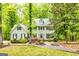 Charming two-story home featuring a lush, landscaped yard and a welcoming entrance framed by mature trees at 120 Majesty Ln, Fayetteville, GA 30215