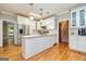 Bright kitchen with stainless steel appliances, white cabinets, and hardwood floors at 120 Majesty Ln, Fayetteville, GA 30215
