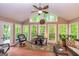 Bright sunroom with brick floor, large windows, and seating area for relaxation at 120 Majesty Ln, Fayetteville, GA 30215