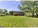 Spacious backyard featuring a large lawn and a view of the back of the house with a deck at 130 Belmont Farms Dr, Ellenwood, GA 30294