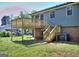 Backyard deck with stairs descending to the lawn offering an outdoor living space at 130 Belmont Farms Dr, Ellenwood, GA 30294