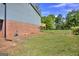 A brick home and grassy backyard at 130 Belmont Farms Dr, Ellenwood, GA 30294