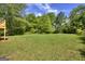 This large backyard has mature trees and lush greenery at 130 Belmont Farms Dr, Ellenwood, GA 30294
