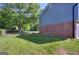 View of the backyard featuring a partial view of the side of the brick and siding house at 130 Belmont Farms Dr, Ellenwood, GA 30294