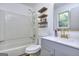 Updated bathroom with modern vanity, stylish mirror, and a shower-tub combination at 130 Belmont Farms Dr, Ellenwood, GA 30294