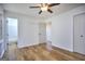 Spacious bedroom featuring a ceiling fan, hardwood floors, and a view into the bathroom at 130 Belmont Farms Dr, Ellenwood, GA 30294