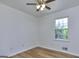 This bright bedroom has hardwood floors, a ceiling fan, and a window for natural light at 130 Belmont Farms Dr, Ellenwood, GA 30294
