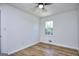 Bright bedroom features hardwood floors, a ceiling fan, and a window for natural light at 130 Belmont Farms Dr, Ellenwood, GA 30294