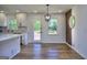 Bright dining area featuring a modern light fixture, a side accent wall, and a door to the outside at 130 Belmont Farms Dr, Ellenwood, GA 30294