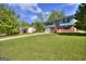 Well-maintained lawn and landscape surround a brick home with an attached garage and a long driveway at 130 Belmont Farms Dr, Ellenwood, GA 30294