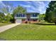 Inviting exterior view of a two-story brick home with a well-kept lawn and blue trim accents at 130 Belmont Farms Dr, Ellenwood, GA 30294