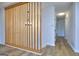 Hallway features natural wood tones, wood floors, and wood slat partition at 130 Belmont Farms Dr, Ellenwood, GA 30294