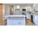 Bright white kitchen features quartz counters, stainless appliances, and an eat-in island at 130 Belmont Farms Dr, Ellenwood, GA 30294