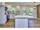 A bright white kitchen features quartz counters, stainless appliances, and eat-in island at 130 Belmont Farms Dr, Ellenwood, GA 30294