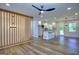 Bright open-concept living space with wood floors seamlessly connecting the kitchen and living areas at 130 Belmont Farms Dr, Ellenwood, GA 30294
