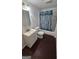 Compact bathroom featuring linoleum flooring, a vanity with sink, a bathtub and shower combination at 1973 Niskey Lake Sw Rd, Atlanta, GA 30331